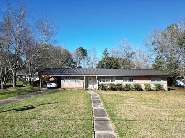 ranch-style house featuring a carport, metal roof, and a front lawn