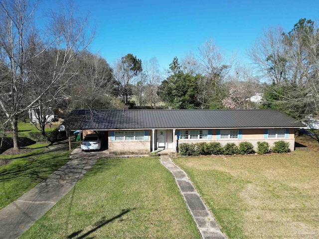 ranch-style home with driveway, metal roof, a front lawn, and an attached carport