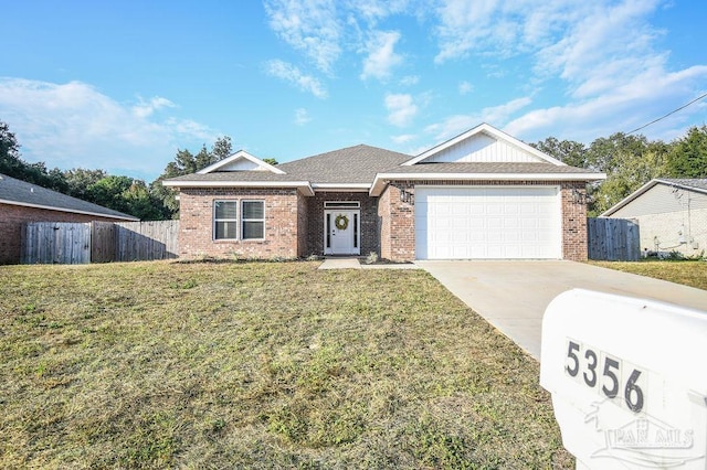 view of front of house featuring a front yard and a garage