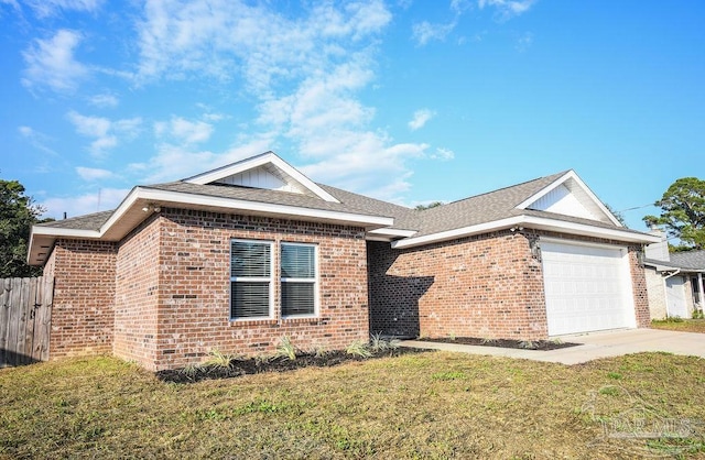 view of front of property with a front yard and a garage