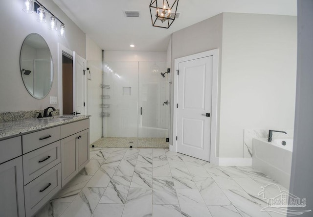 bathroom featuring shower with separate bathtub and vanity