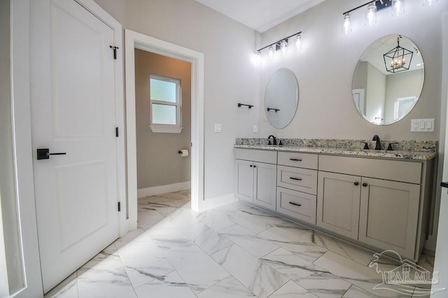 bathroom with vanity and an inviting chandelier