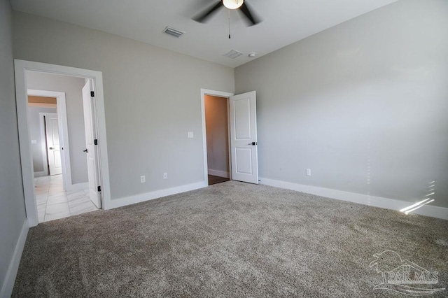 unfurnished bedroom with ceiling fan and light colored carpet