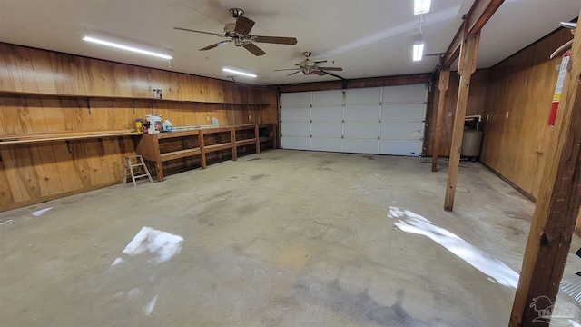 garage with ceiling fan and wood walls