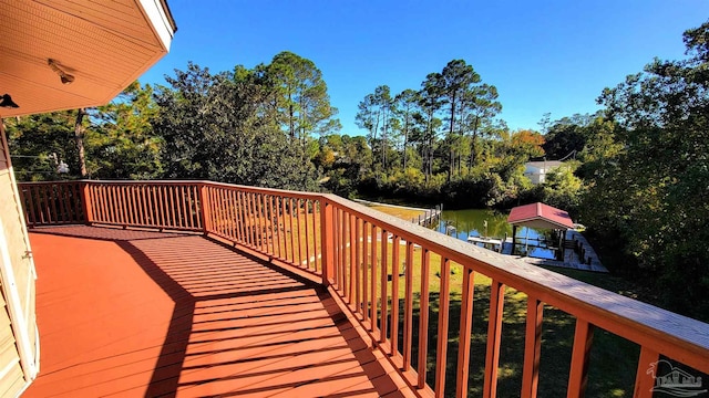 wooden terrace with a water view and a dock