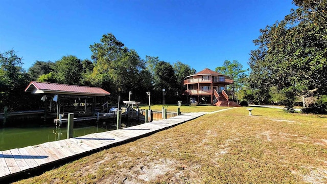 dock area with a yard and a water view