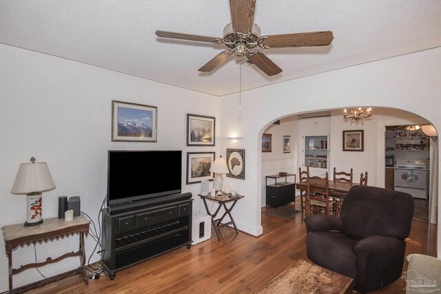 living room featuring a textured ceiling, ceiling fan with notable chandelier, and hardwood / wood-style floors