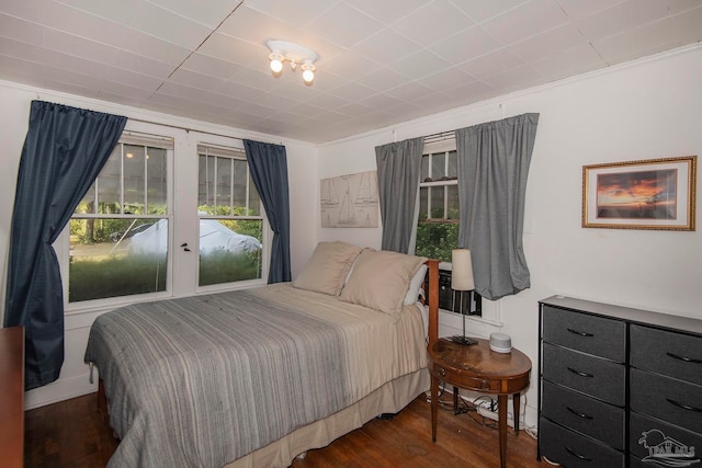 bedroom with french doors and dark wood-type flooring