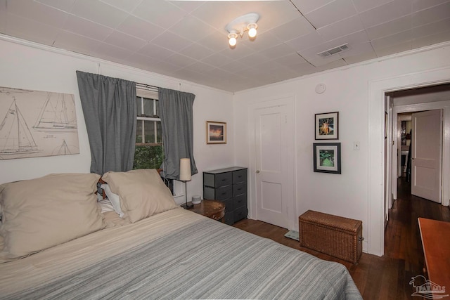 bedroom with dark wood-type flooring