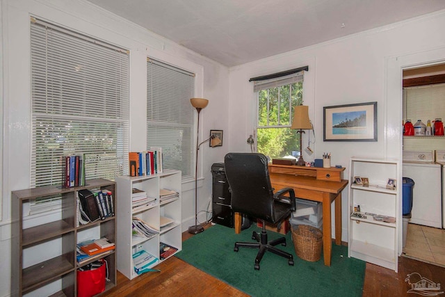 office area featuring hardwood / wood-style floors, washer / dryer, and ornamental molding