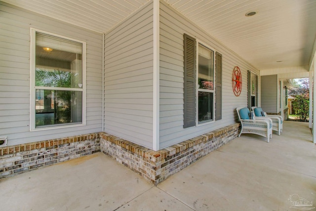 view of side of property with a porch