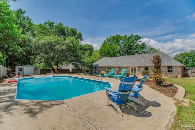 view of pool with a shed, a fenced backyard, an outdoor structure, a patio, and a fenced in pool