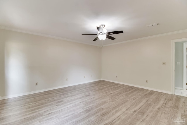 unfurnished room featuring visible vents, a ceiling fan, ornamental molding, light wood-style floors, and baseboards