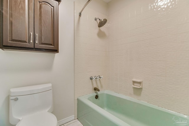 bathroom with tile patterned flooring, tub / shower combination, toilet, and baseboards