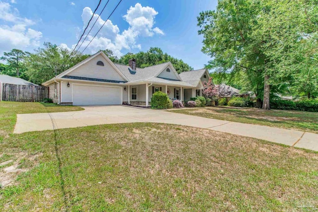 view of front of home with a garage, concrete driveway, covered porch, fence, and a front yard