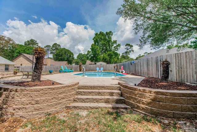 view of swimming pool with a patio area, a fenced in pool, and a fenced backyard