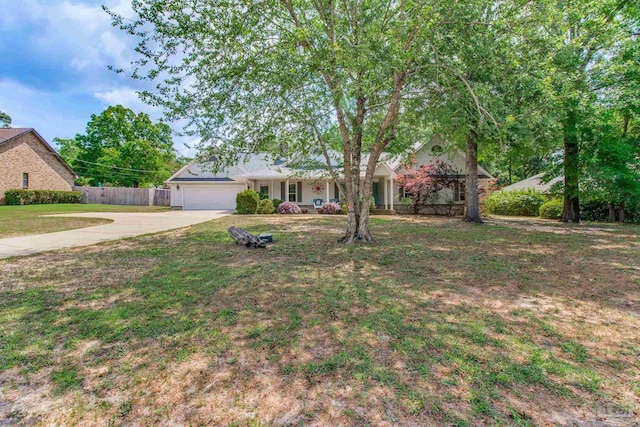 ranch-style house featuring a garage, a front yard, concrete driveway, and fence