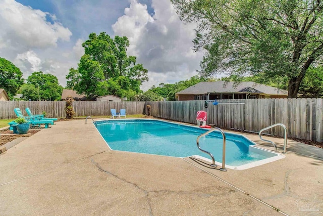 view of swimming pool with a patio area, a fenced in pool, and a fenced backyard