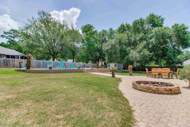 view of yard featuring a fenced backyard, an outbuilding, and a shed