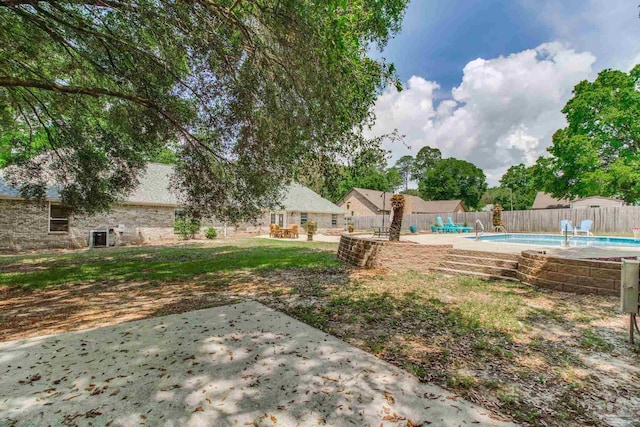 view of yard featuring a fenced backyard, a fenced in pool, and a patio