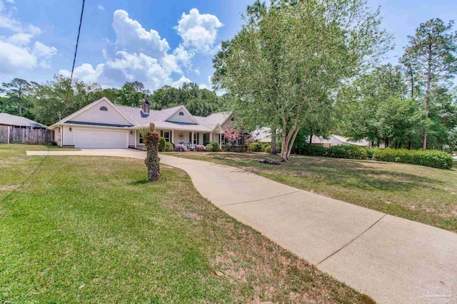 view of front of house featuring a chimney, fence, driveway, a front yard, and a garage