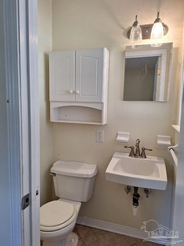 bathroom with tile patterned floors, toilet, and sink