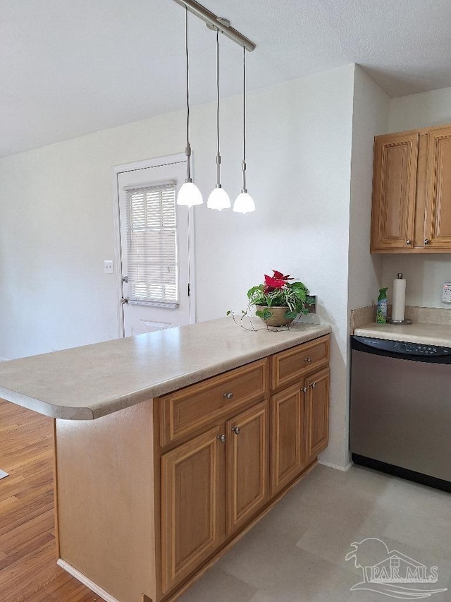 kitchen with hanging light fixtures, a kitchen breakfast bar, dishwasher, stainless steel fridge, and kitchen peninsula