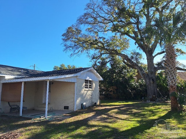 view of home's exterior featuring a yard and a patio