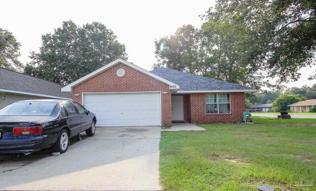 ranch-style home featuring a garage and a front lawn