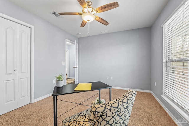 carpeted office with ceiling fan