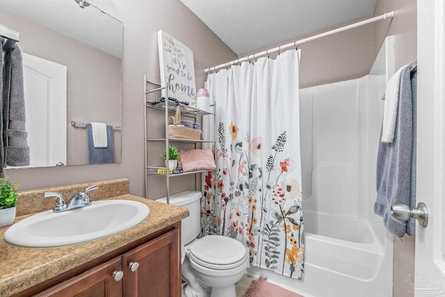 full bathroom featuring vanity, shower / tub combo, a textured ceiling, and toilet