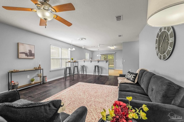 living room with dark hardwood / wood-style floors and ceiling fan