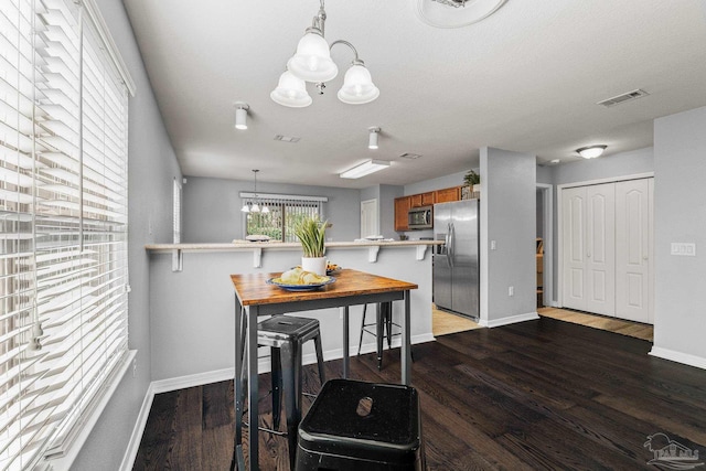 dining room featuring hardwood / wood-style floors and a notable chandelier