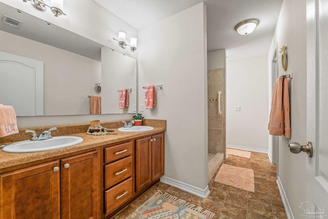 bathroom featuring vanity and tiled shower