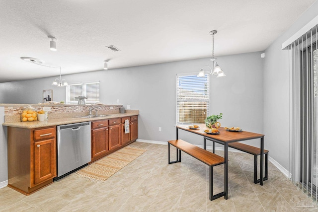 kitchen featuring decorative light fixtures, sink, a chandelier, stainless steel dishwasher, and a textured ceiling