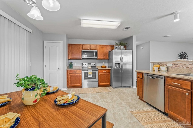 kitchen featuring appliances with stainless steel finishes, sink, and backsplash