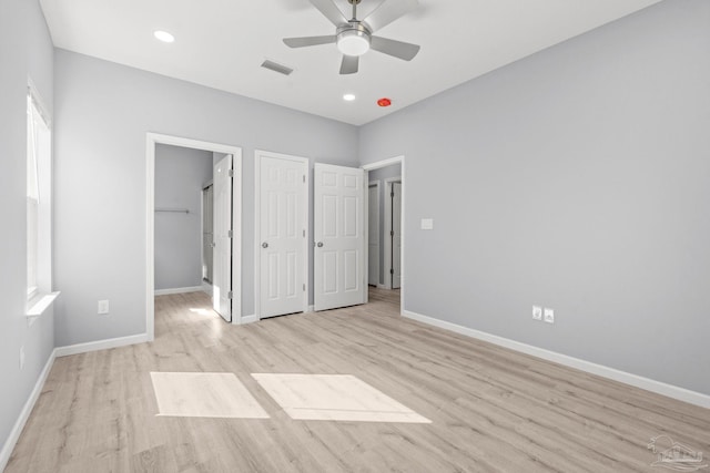 unfurnished bedroom with light wood-style floors, baseboards, and visible vents