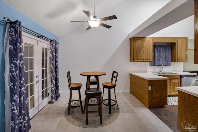 tiled dining area with lofted ceiling, ceiling fan, french doors, and sink