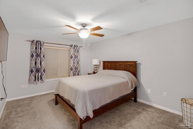 carpeted bedroom featuring ceiling fan and a textured ceiling