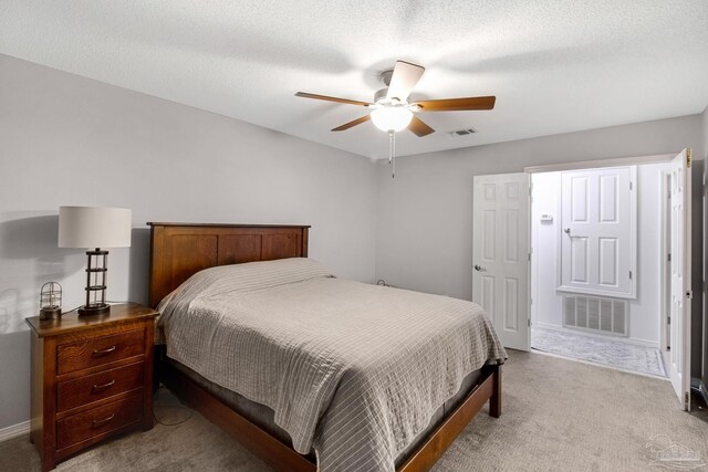 bathroom featuring walk in shower, a textured ceiling, tile patterned flooring, and vanity