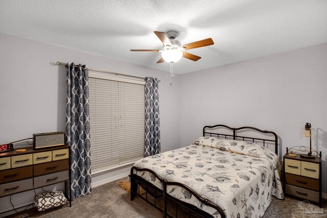 carpeted bedroom with ceiling fan and a textured ceiling