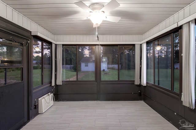 unfurnished sunroom featuring ceiling fan and wooden ceiling