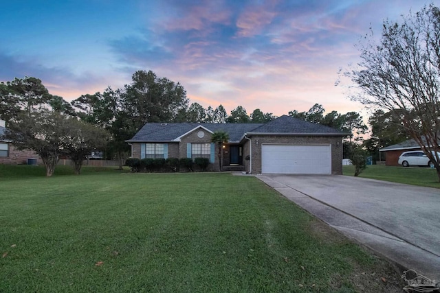 single story home with a yard and a garage