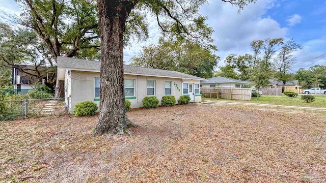 single story home featuring fence and stucco siding