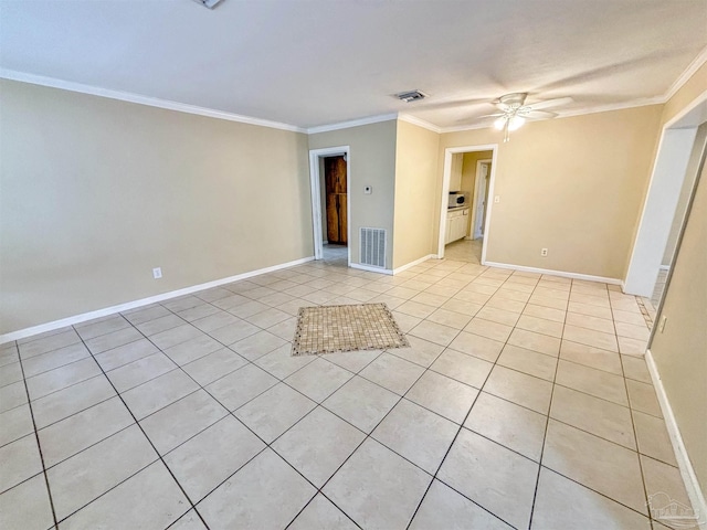 unfurnished room with crown molding, light tile patterned floors, visible vents, ceiling fan, and baseboards