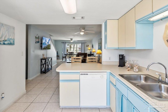 1440 Paradise Point Dr Unit 13, Navarre Beach, FL 32566 - kitchen with dishwasher, a peninsula, a ceiling fan, light countertops, and light tile patterned flooring