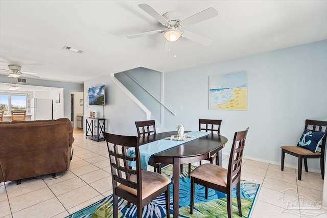 1440 Paradise Point Dr Unit 13, Navarre Beach, FL 32566 - dining area featuring ceiling fan, light tile patterned floors, and stairs