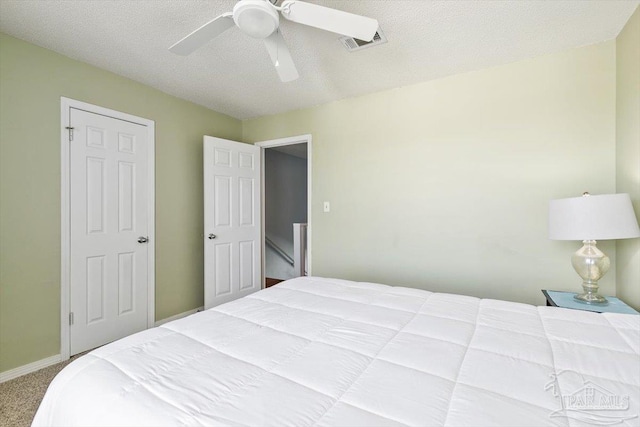 1440 Paradise Point Dr Unit 13, Navarre Beach, FL 32566 - bedroom with carpet flooring, a ceiling fan, and a textured ceiling