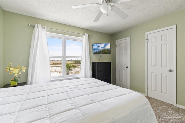 1440 Paradise Point Dr Unit 13, Navarre Beach, FL 32566 - bedroom with carpet, a textured ceiling, and a ceiling fan