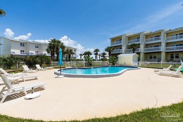 1440 Paradise Point Dr Unit 13, Navarre Beach, FL 32566 - community pool featuring a patio area